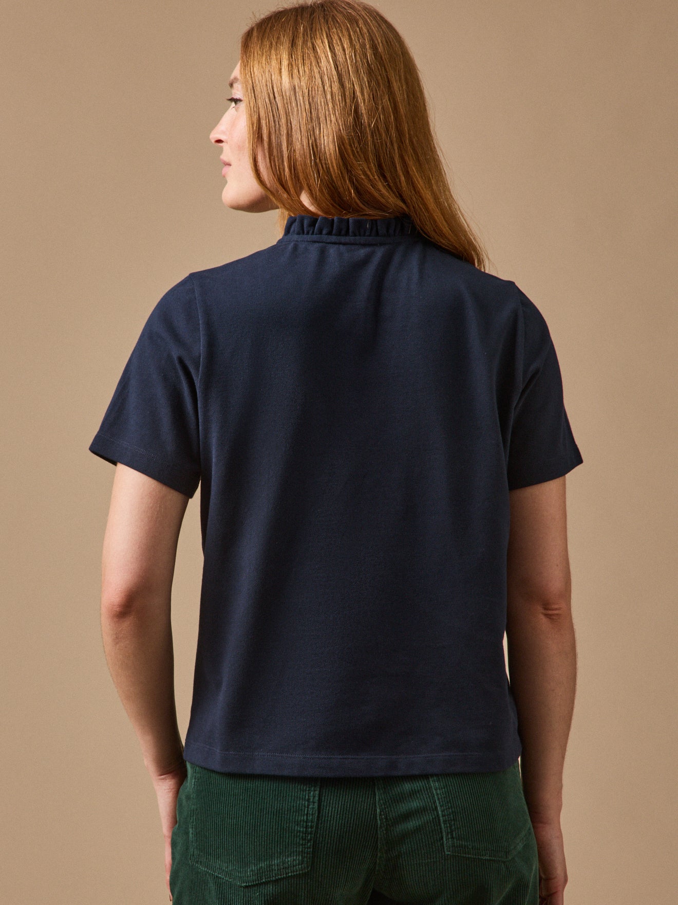 Polo maille piquée col volanté femme